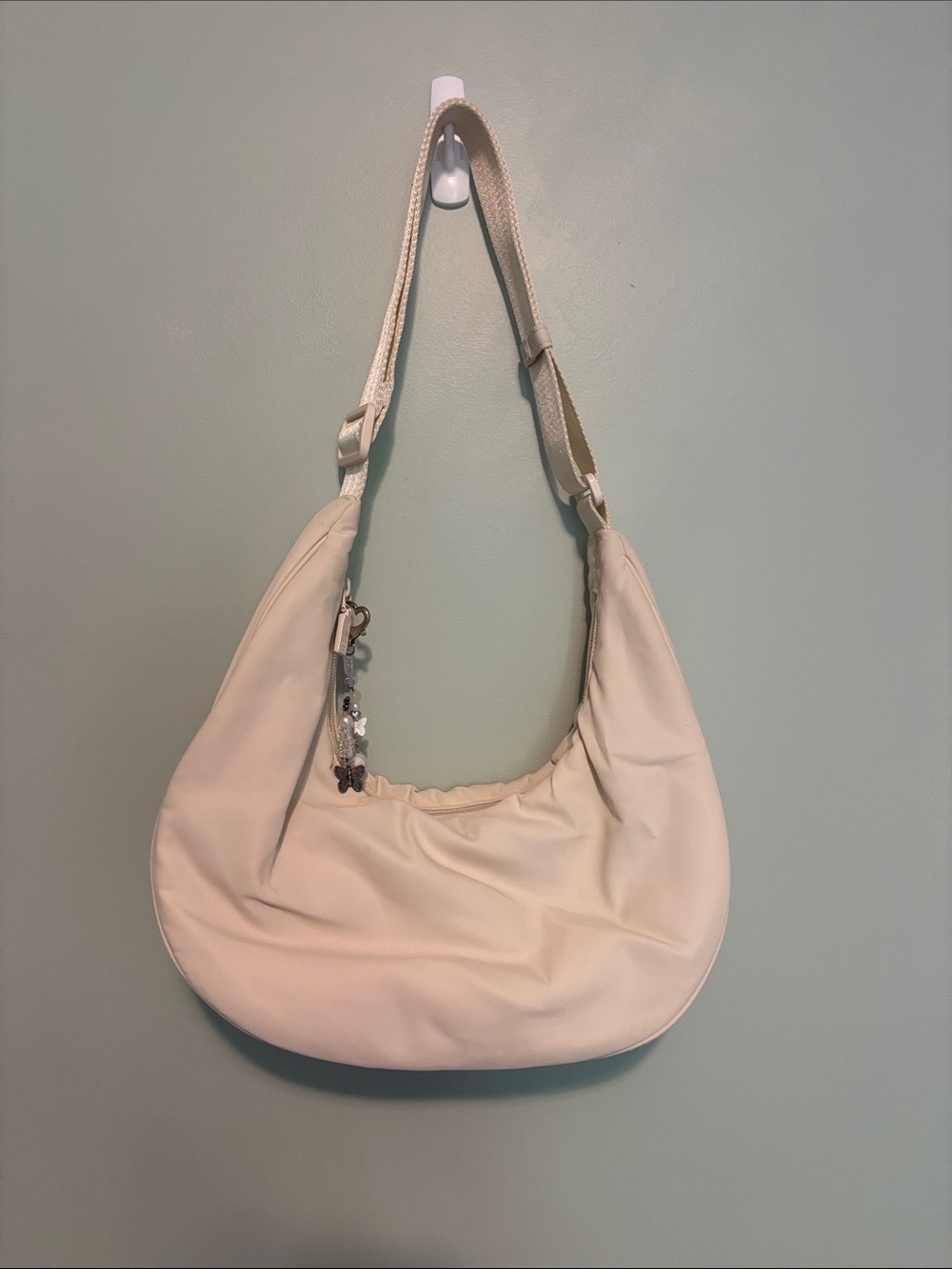 Aritzia Sunday Best beige nylon bag with charm